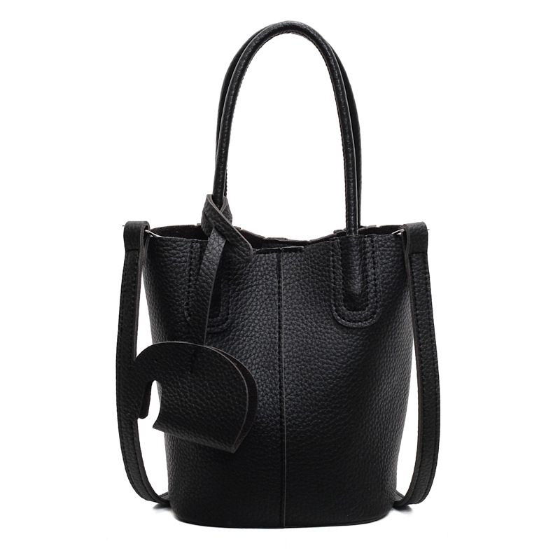 Bolso de cubo de venta caliente de comercio exterior, sentido de alta gama de nicho femenino 2025 nuevo bolso de mano simple y versátil, bolso de mensajero de moda y versátil