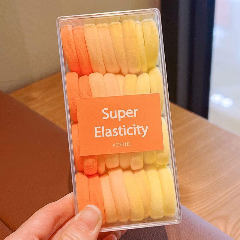 32 cajas con anillos amarillos para el cabello