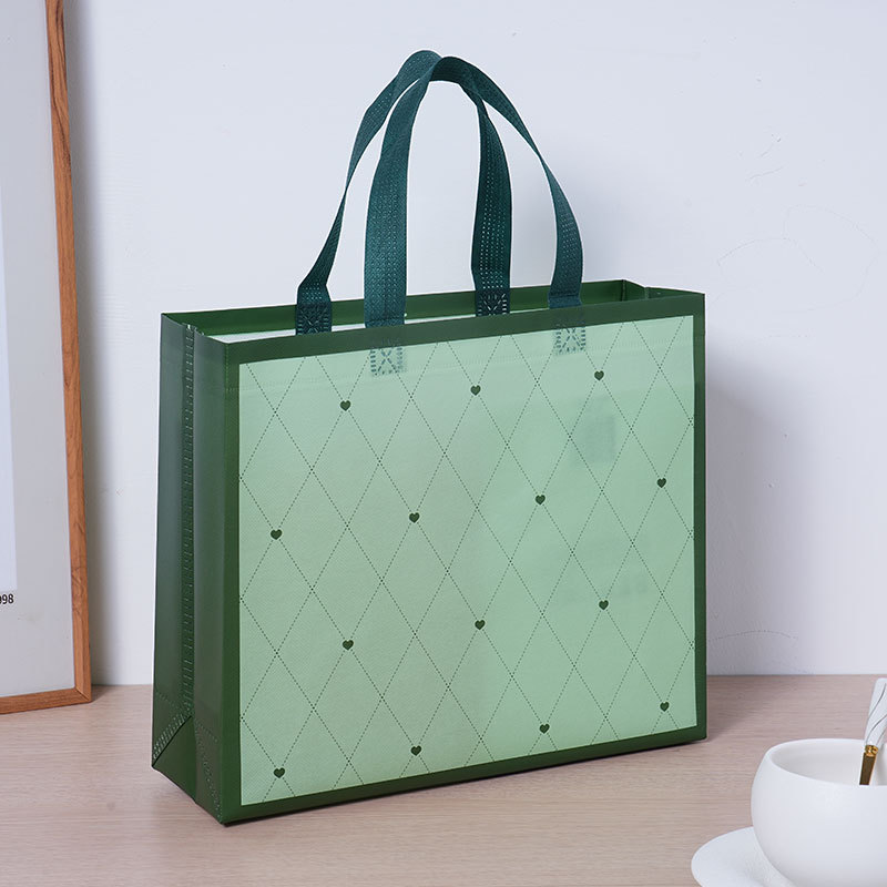 Bolsas de tela no tejida cubiertas de amor verde personalizadas atmósfera simple de alto valor de color bolsas de hombres y mujeres clásicas impermeables engrosadas