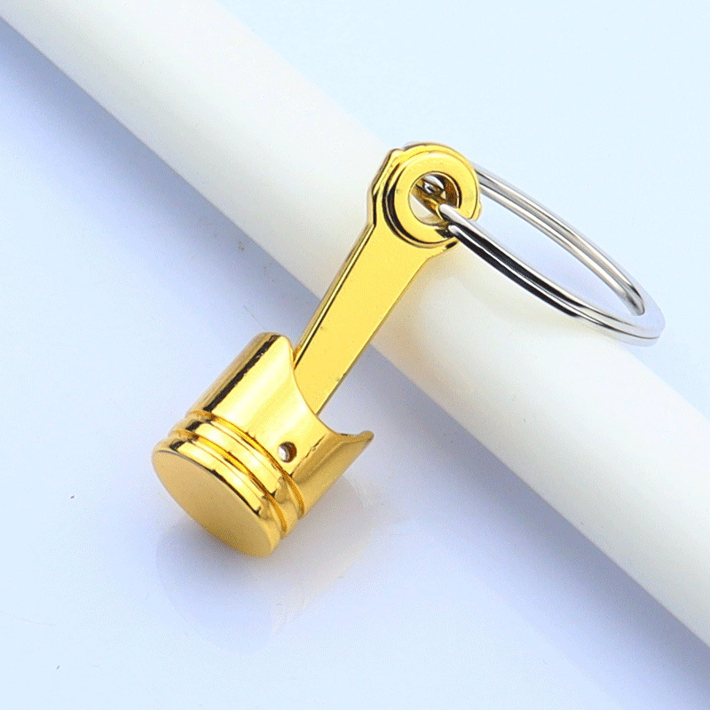 Nuevo coche transfronterizo motor pistón llavero colgante coche modificación creativa pequeño regalo letras logotipo impreso