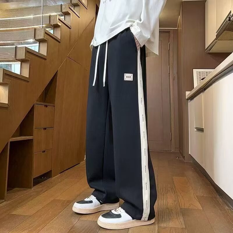 Pantalones casuales de hombre, tendencia de otoño y invierno, pantalones rectos de tamaño grande, pantalones deportivos elásticos de cintura delgada y caída.