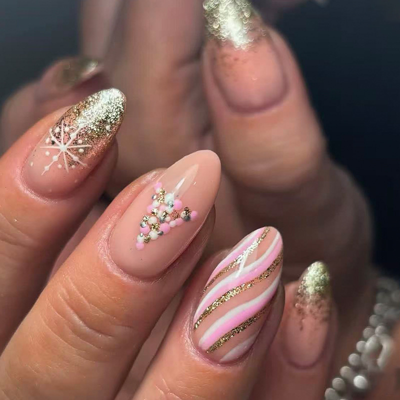 Medium almond-shaped Christmas manicure with gold glitter, French-style nails, pink stripes, Christmas tree and snowflake designs, press-on nails