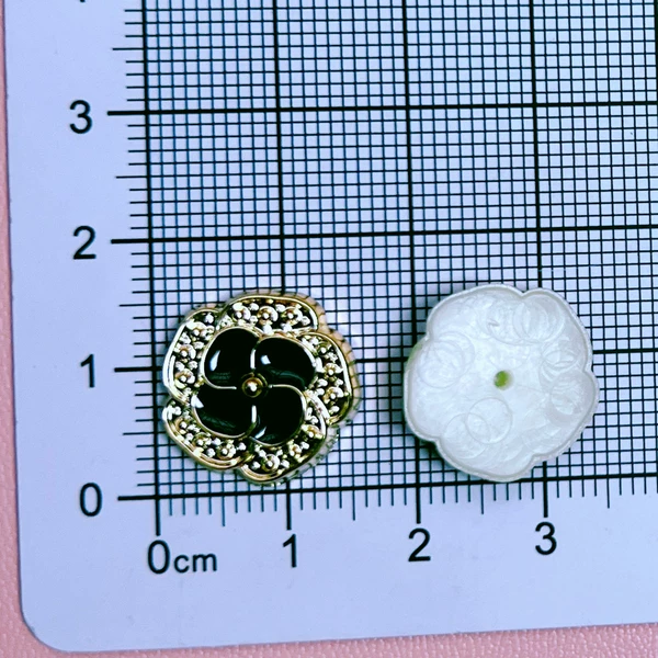 Small black flowers with gold edge