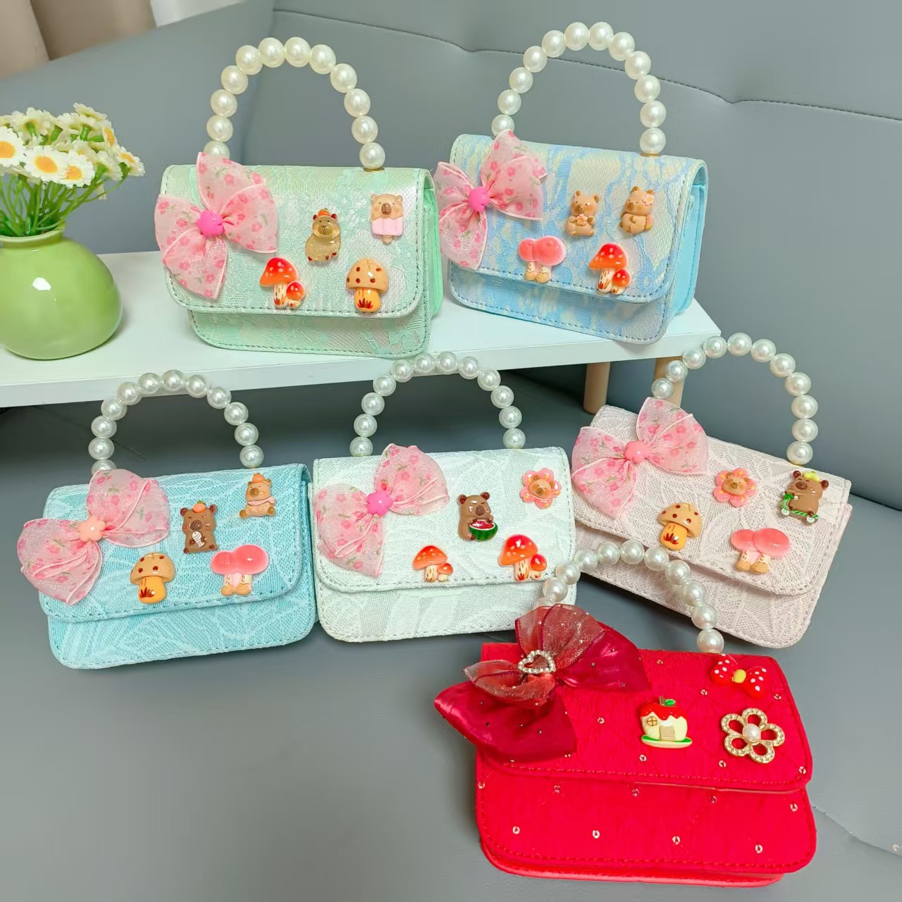 Bolsos para niños nuevos bolsos de perlas de arco para niñas bolsos de cinturón de estilo de fragancia bolsos de cadena bolsos de cambio bolsos