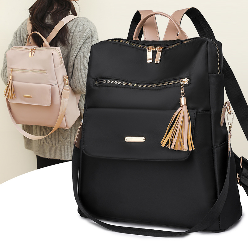 Fábrica al por mayor 2023 nueva versión coreana de la mochila de nailon para mujer moda literaria color de contraste viaje mochila de doble uso marea