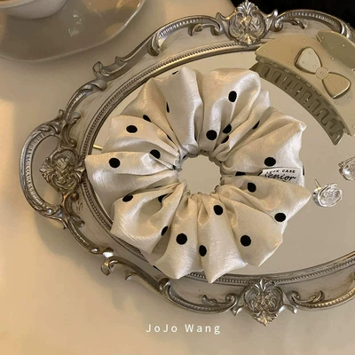 The texture is amazing! The pearlescent dots give it a classy look. This scrunchie is a stylish Korean fashion hair accessory for women (Saç üçün rezinlər) - beige-polka-dot-hair-tie