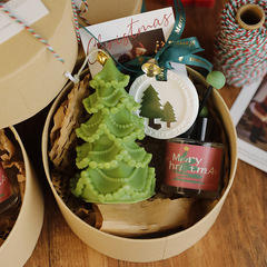 クリスマスの祝日にお土産をプレゼントします。クリスマスツリーの形のアロマキャンドルの高級感があります。