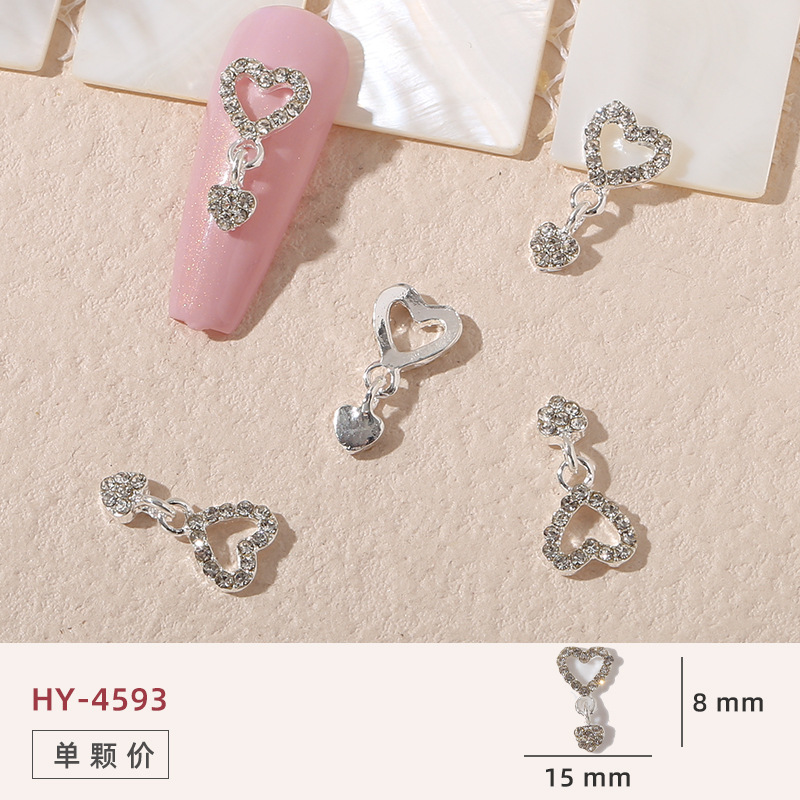 Uñas mariposa joyería nueva línea popular perla arco metal decoración de uñas pequeños accesorios de joyería al por mayor