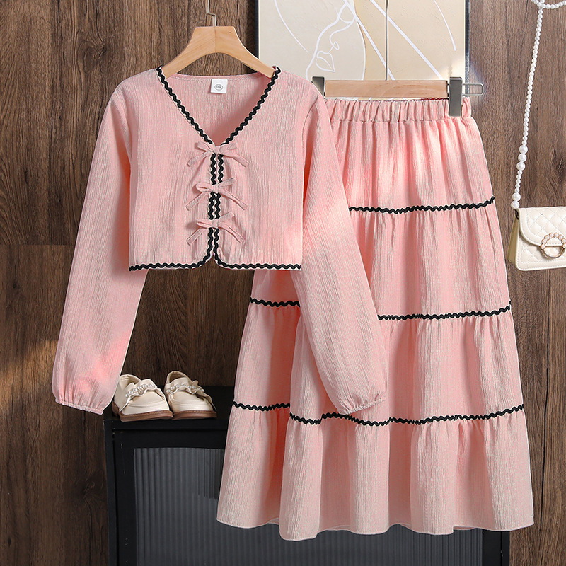Ropa para niñas de comercio exterior europeo y americano, nueva colección primavera 2026, top de manga larga con lazo y falda de encaje para Amazon transfronterizo.