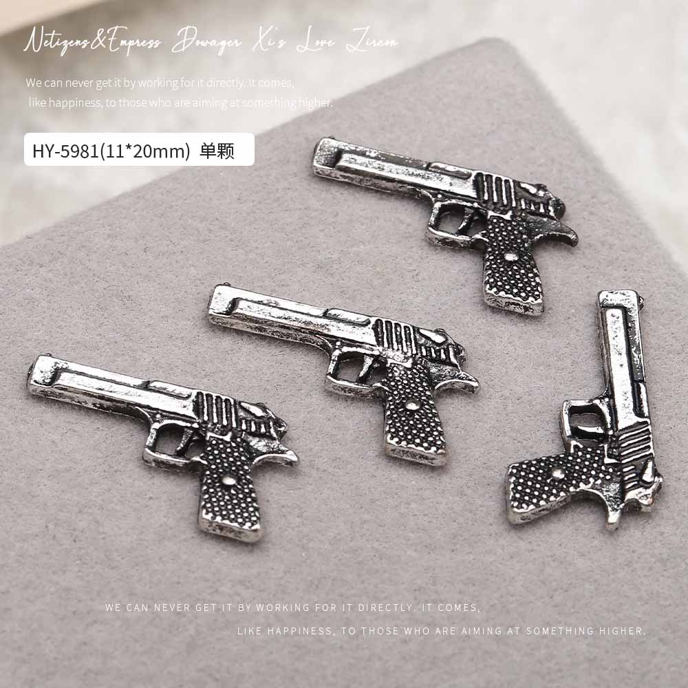 Europa y los Estados Unidos en línea con diamantes AK armas de manicuría joyas de simulación de personalidad tridimensional armas de fuego decoración de uñas al por mayor