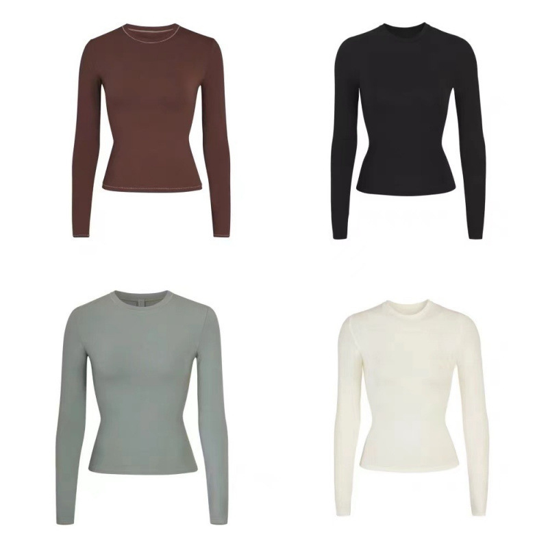 Skims Kardashian-style slim-fit long-sleeve T-shirt, a versatile base layer with a cinched waist, round neckline, and a slimming effect, available in solid colors
