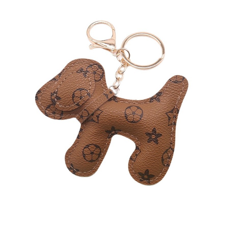 多色の創意的な子犬の鍵は革の掛け物を掛けます。|undefined