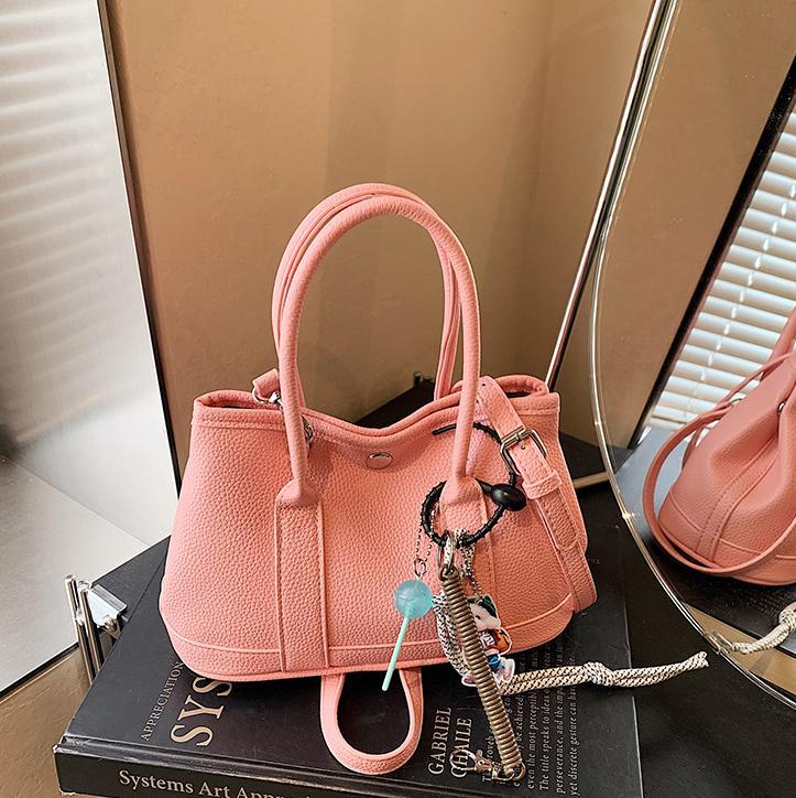 Nicho de moda explosivo bolso de cubo portátil para mujeres 2025 nuevo estilo universal simple bolso de mochila de moda extranjera bolso de mochila