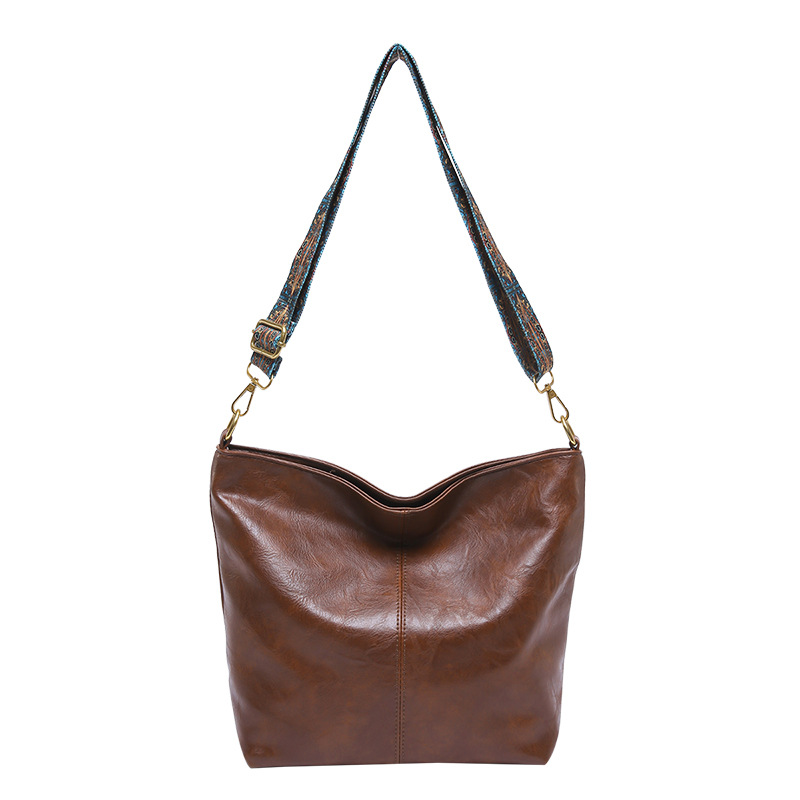 Bolso coreano de gran capacidad para mujeres 2024 otoño y invierno nuevo retro banda ancha mochila de hombro texturizada bolso de cubo de viaje