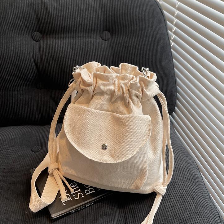 Bolsa de cubo de lona de moda de comercio exterior para mujeres 2025 nuevo estilo versátil bolso de hombro simple ocio nicho plegado mochila