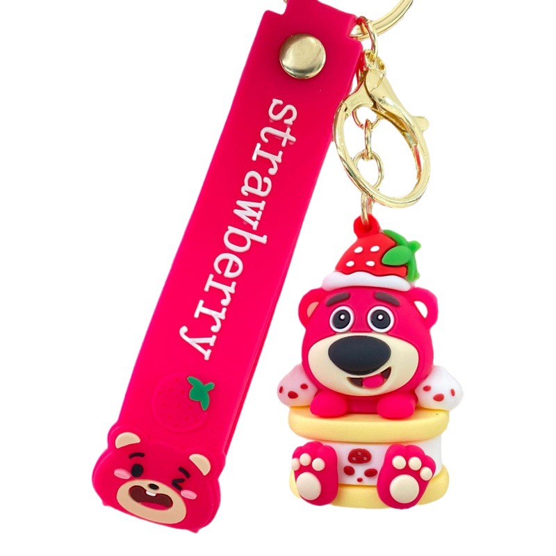 Nueva historieta en línea celebridad codicioso fresa oso llavero muñeca coche bolsa bebé captura máquina colgante llavero al por mayor