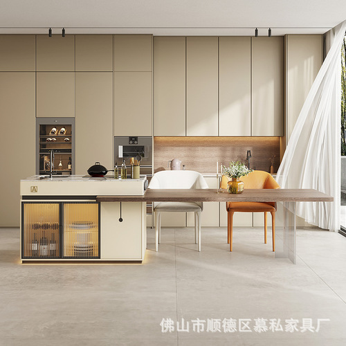 A stone slab island table with integrated tea table, induction cooktop, and extendable design, creating a versatile floating island in an open-concept kitchen.