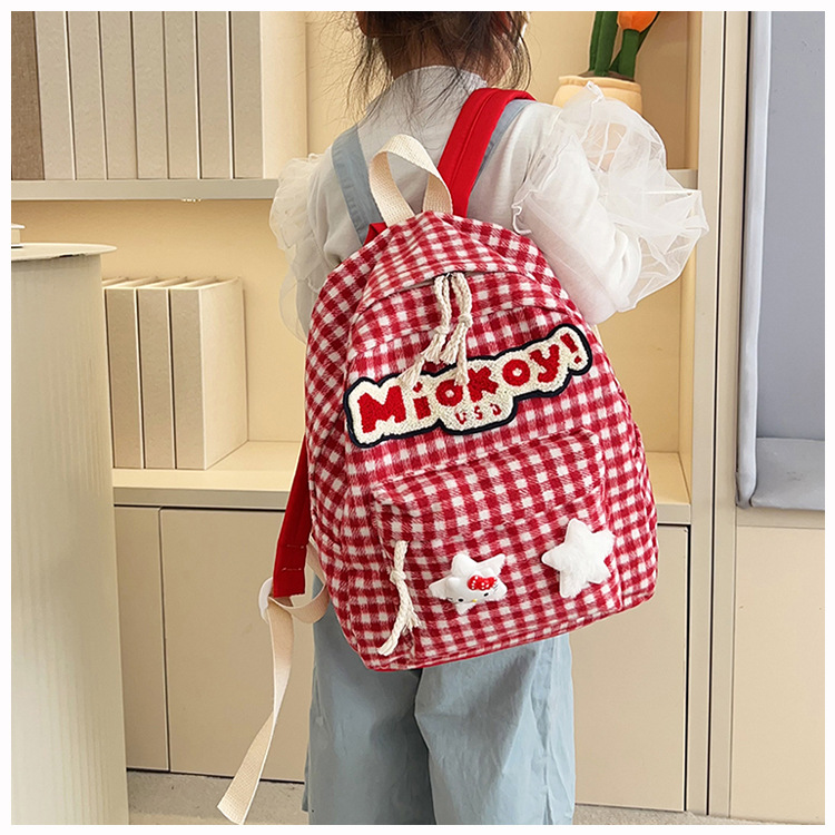 The large-capacity red woolen checkered backpack for primary and secondary school students is a unique and versatile choice. It's a trend for girls to carry backpacks during their leisure trips undefined