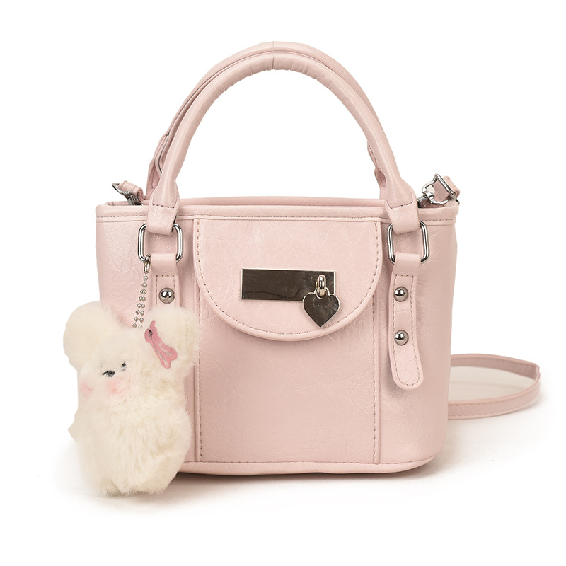 Nuevo bolso infantil transfronterizo simple bolso de bebé compacto color sólido lindo muñeca colgante bolso de cubo para hombres y mujeres