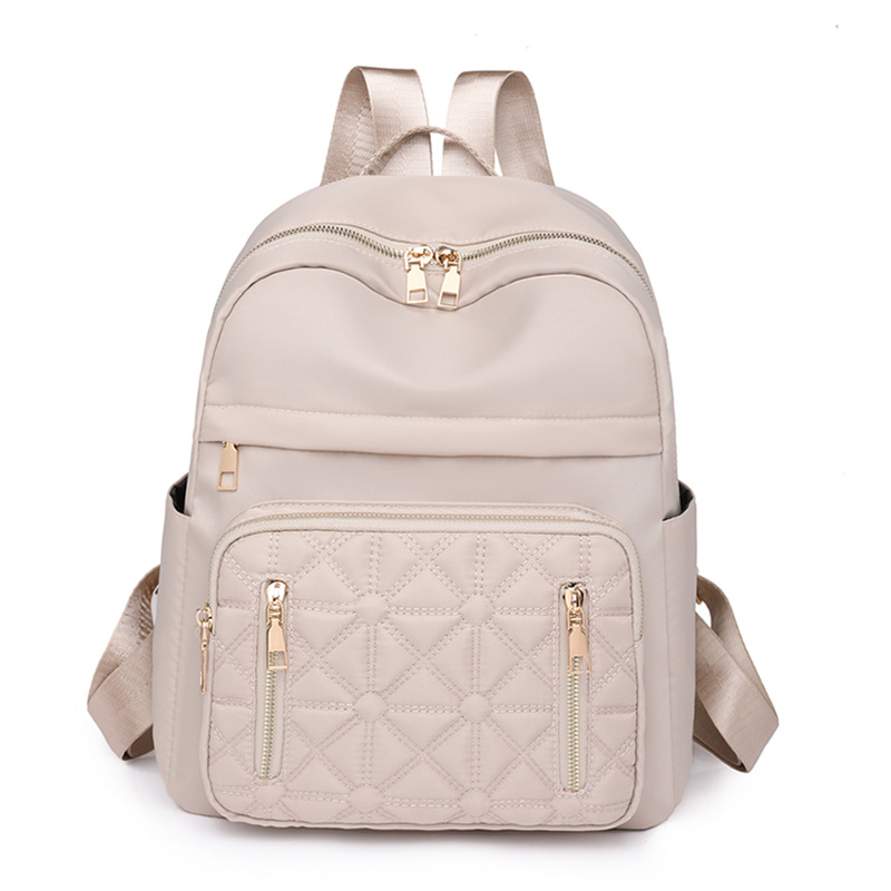 Comercio exterior al por mayor 2023 nueva versión coreana de la mochila de nailon para mujer, línea de bordado de moda, mochila de viaje al aire libre de todo fósforo, marea