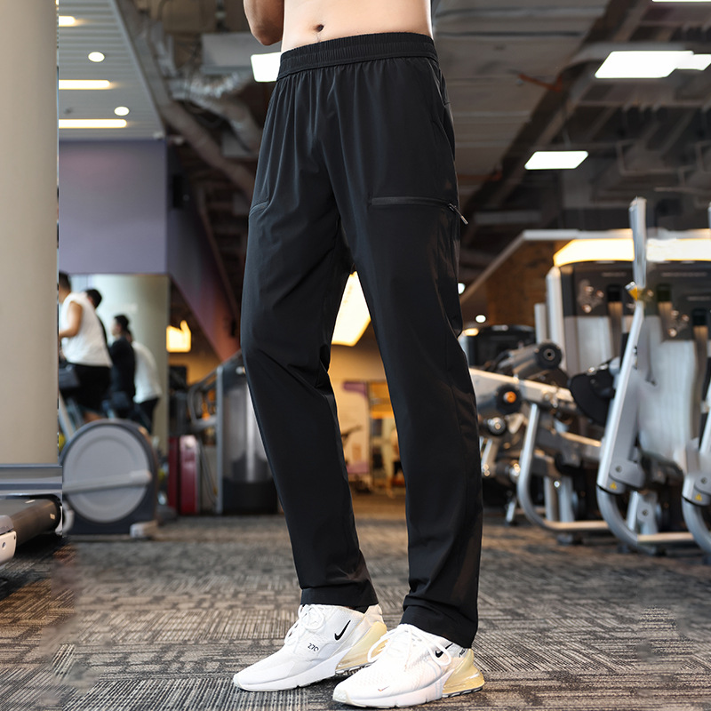 Pantalones deportivos elásticos de cuatro lados de nylon otoño de los hombres corriendo fitness casual Pantalones deportivos ligeros pantalones especiales americanos