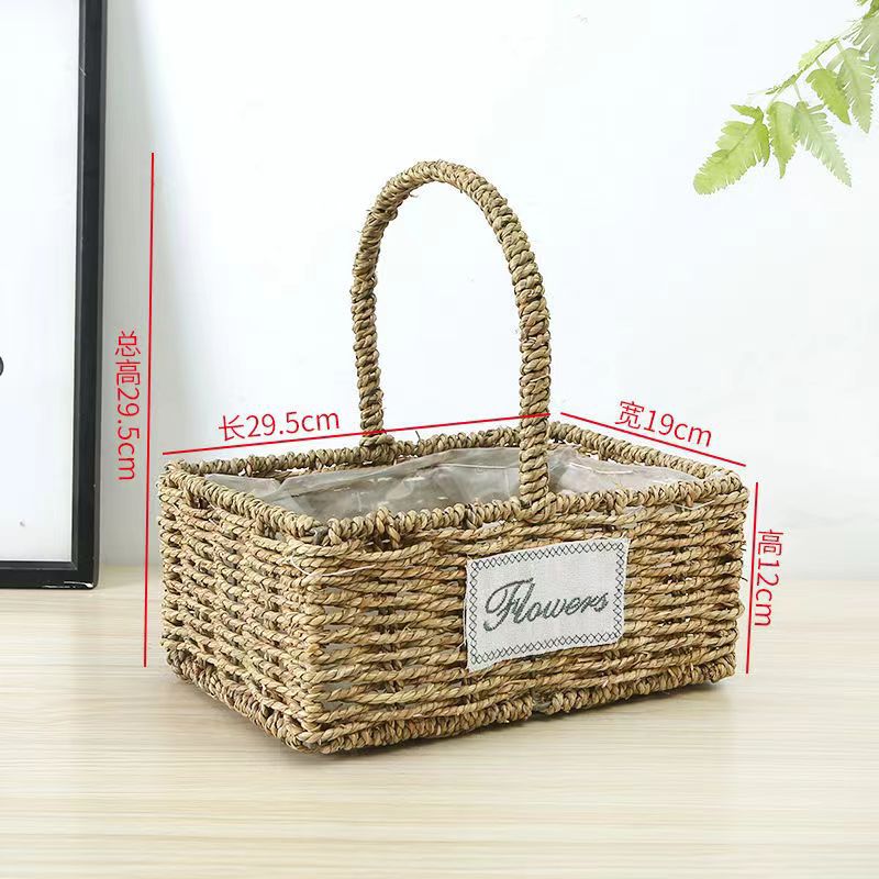 Fabricantes de cestas de flores ovales rectas de paja hechas a mano en stock al por mayor cestas de flores de paja portátiles decoración de viento pastoral