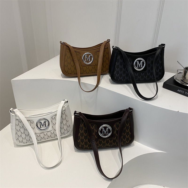 Bolsas debajo de las axilas para mujeres 2025 primavera nueva moda texturas francesas nicho bolsas de hombro letras de impresión media luna bolsas de mujer