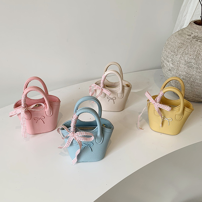 Nuevo bolso para niños coreano simple color sólido bolso de cubo para niños y niñas lindos arco mini bolso de mano bebé