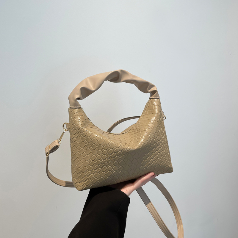 Este año bolsos populares de mujer diseño de tejido bolsos de mochila coreanos bolsos de transporte de aire extranjero 2024 nueva moda bolsos de hombro