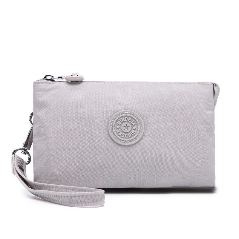 Bolsa de mano de nylon multicapa de gran capacidad a prueba de derrames de agua de mujer simple de moda larga cremallera cambio pasaporte bolso móvil