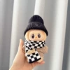 Black and white plaid scarf + small black expression hat + brown smiling pin shirt