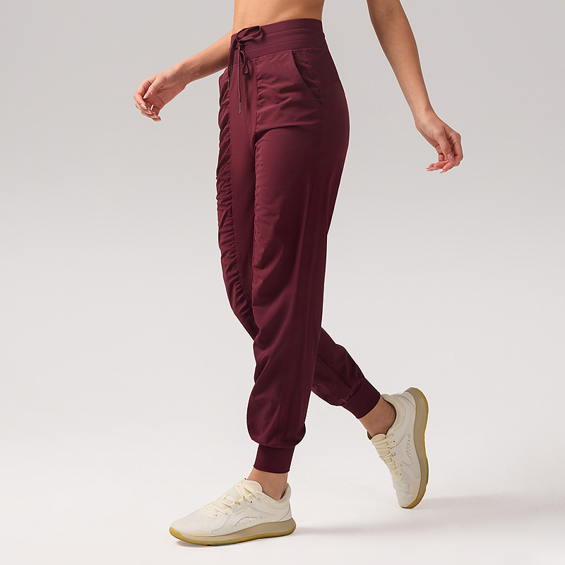Pantalones deportivos casuales sueltos de mujer plegados para correr pantalones de yoga de nueve puntos de bolsillo secado rápido pantalones de pies transpirables