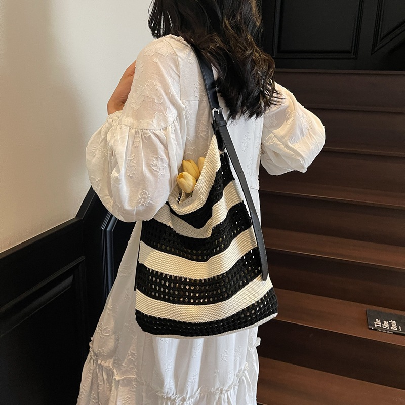 Verano 2025 nuevo estilo bolso tote tejido hueco de gran capacidad raya femenina balde de vacaciones junto al mar bolso tejido de paja