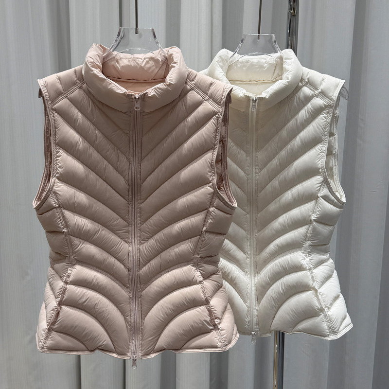 95% white duck down, slim-fit, short-length, stand-up collar, lightweight, versatile vest for layering or wearing on its own 95% white duck down, slim-fit, short-length, stand-up collar, lightweight, versatile vest for layering or wearing on its own