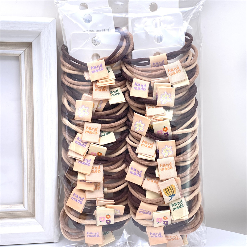 Caqui fresa oso etiqueta de tela anillo de pelo rojo leche té color 03 amor banda de goma lazo de pelo de las mujeres 2 yuanes tienda física