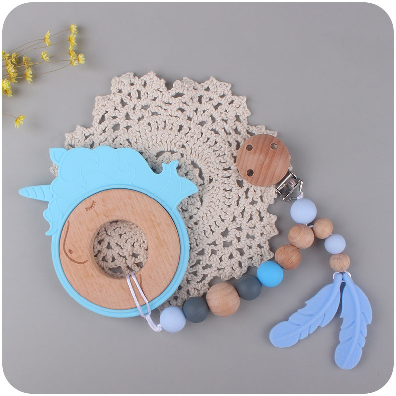 Nuevo bebé suministros de dibujos animados animal unicornio anillo de madera mordedura de bebé de goma molar de juguete de haya