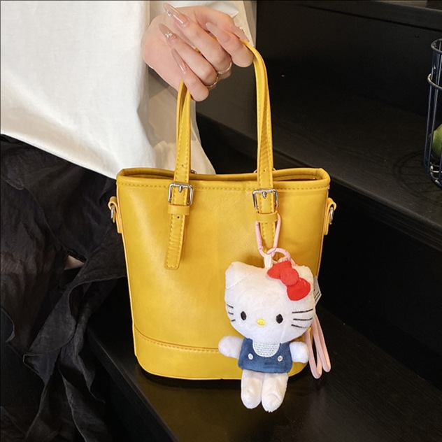 2025 nuevo bolso de cubo portátil de diseño de nicho bolso de hombro de viajero de todo fósforo de moda femenina bolso de mensajero de estilo occidental de color sólido