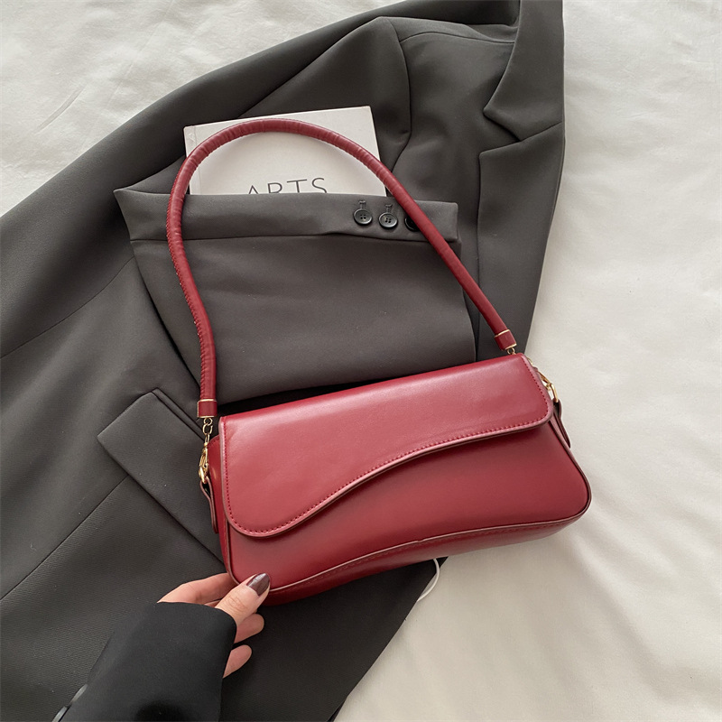 Bolso debajo de la axila para mujeres 2025 primavera nueva moda de alta sensación de hombro mochila de nicho bolso de textura cuadrada