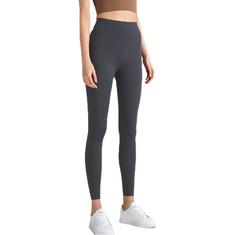 Nuevos pantalones de yoga desnudos transfronterizos Lycra de cintura alta de mujer pantalones de fitness de levantamiento de cadera deportes al aire libre ropa de yoga ajustada de secado rápido