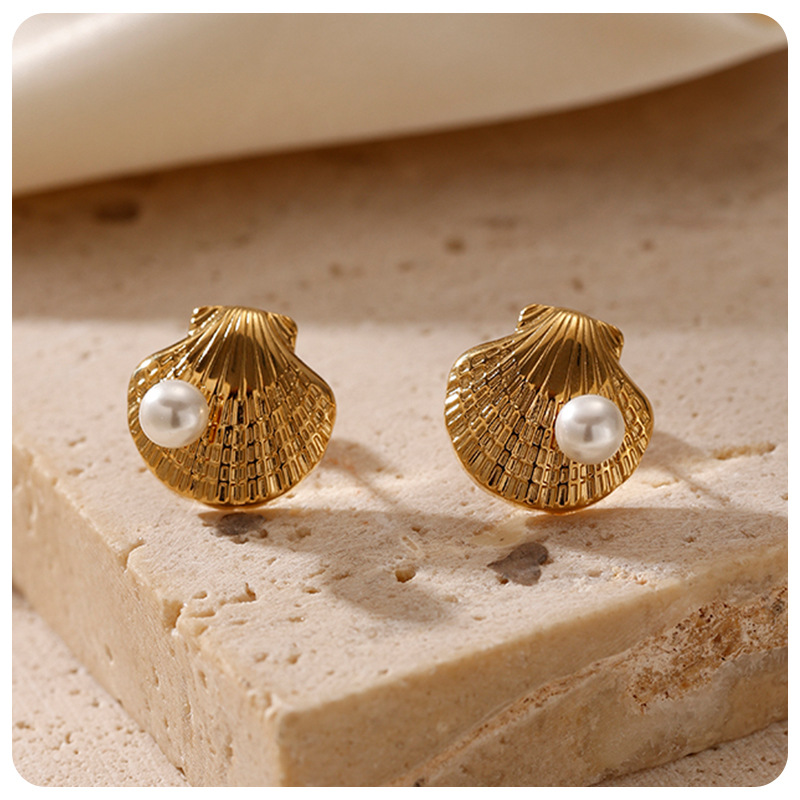 Taina serie de conchas transfronterizas auriculares de acero inoxidable en red con el viento de playa de verano de alta calidad pernos de acero de titanio