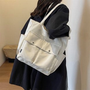 Capacious nylon one-shoulder bag with zipper, decorative stitching
