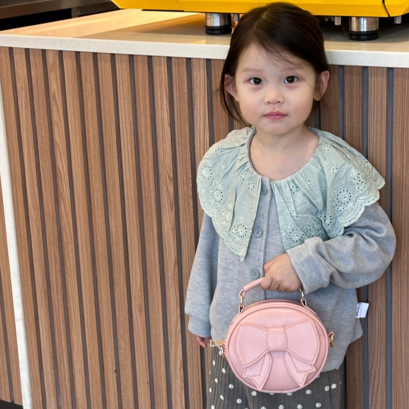 Bolsos para niños mini lindos arcos para hombres y mujeres, bolsos redondos para niños 2025 moda coreana nueva bolsa de cambio para niños