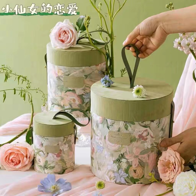 春の絵のにぎやかな丸いバケツのお土産の箱の高級感の花嫁の結婚式の手提げの喜糖の箱の空の箱のプレゼントの箱|undefined