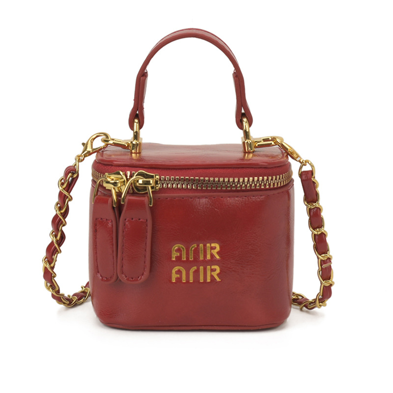 Nuevos bolsos infantiles transfronterizos letras extranjeras mini bolsos de bebé cadena de piel de aceite bolsos de caja de color sólido para niñas