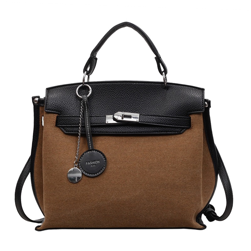 Bolso para mujeres 2026 nuevo cross-border lienzo empalme color contraste bolso de mano alta sensación retro mochila de hombro