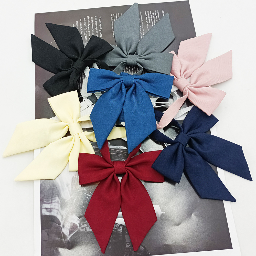 Spot al por mayor versión estrecha niña pequeña pajarita de raíz de plumas pajarita flor moda nuevo lazo color sólido jk pajarita satinado