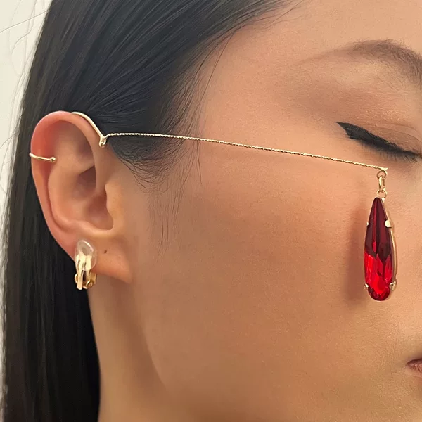 Long, teardrop-shaped crystal drop earrings, clip-on style, no ear piercing required. Features a luxurious design with tassels, perfect for adding a touch of elegance to any occasion