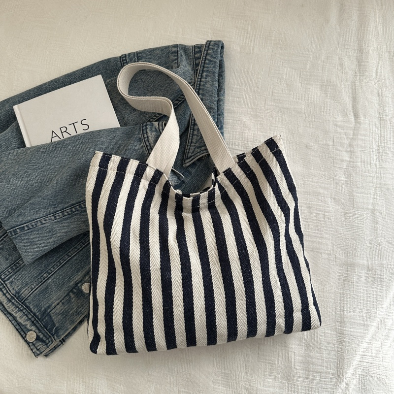 The new cross-border vertical striped commuter tote bag, hand-held shoulder bag, is fashionable and has a large capacity. It features an InS-style simple letter sail undefined
