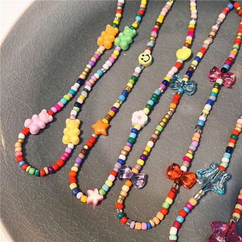 Korean version of the new ins style colorful rice beads beaded mobile phone chain ins fashion bear love flower bow tie pendant for women