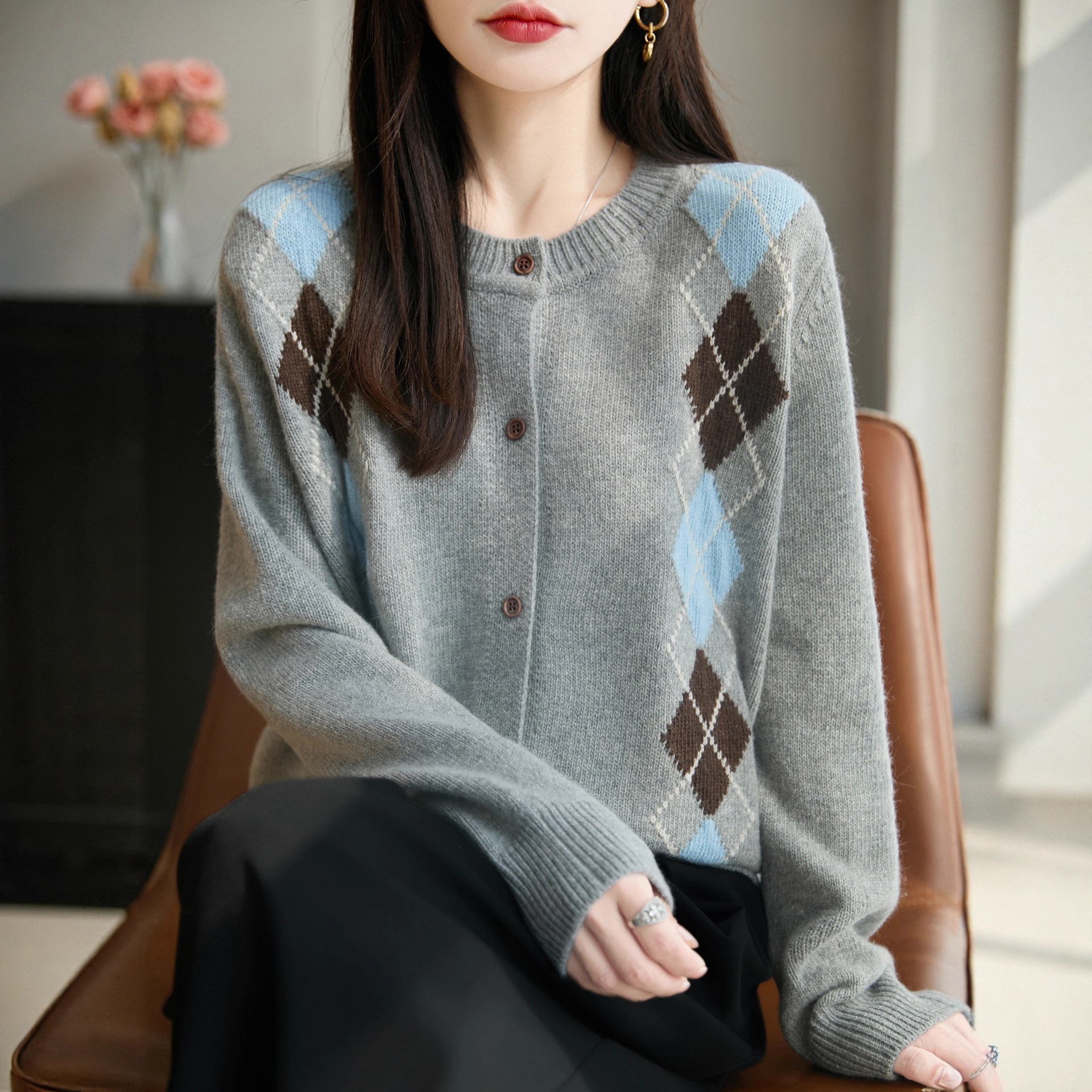 A relaxed-fit, diamond-patterned cardigan for women, featuring colorful geometric contrasts and a loose, color-blocked design. Dark gray top.